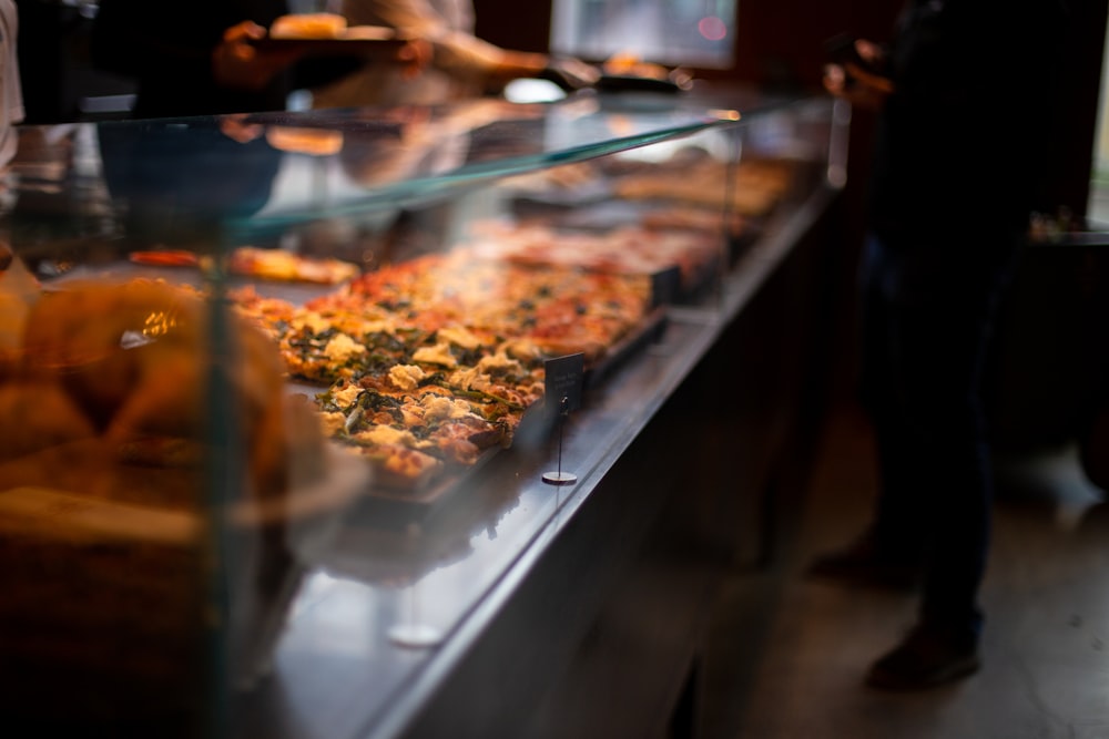 selective focus photography of food inside clear glass display cabinet