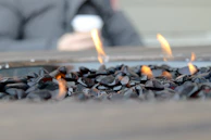 Close-up of sleek stone tiles arranged around a garden fire pit, highlighting texture and craftsmanship.