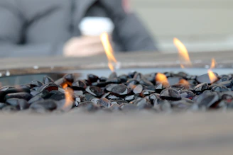 Close-up of sleek stone tiles arranged around a garden fire pit, highlighting texture and craftsmanship.
