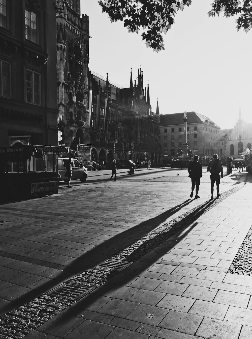 people walking near concrete buildings during daytime