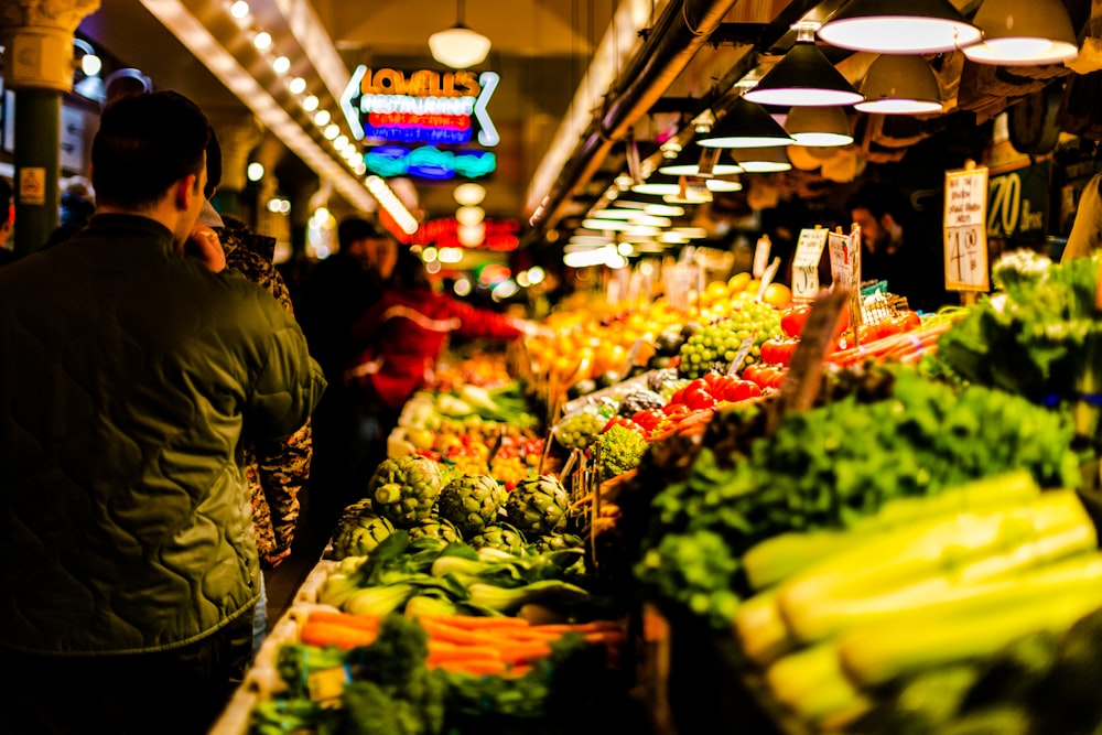 homme marchant à côté de légumes