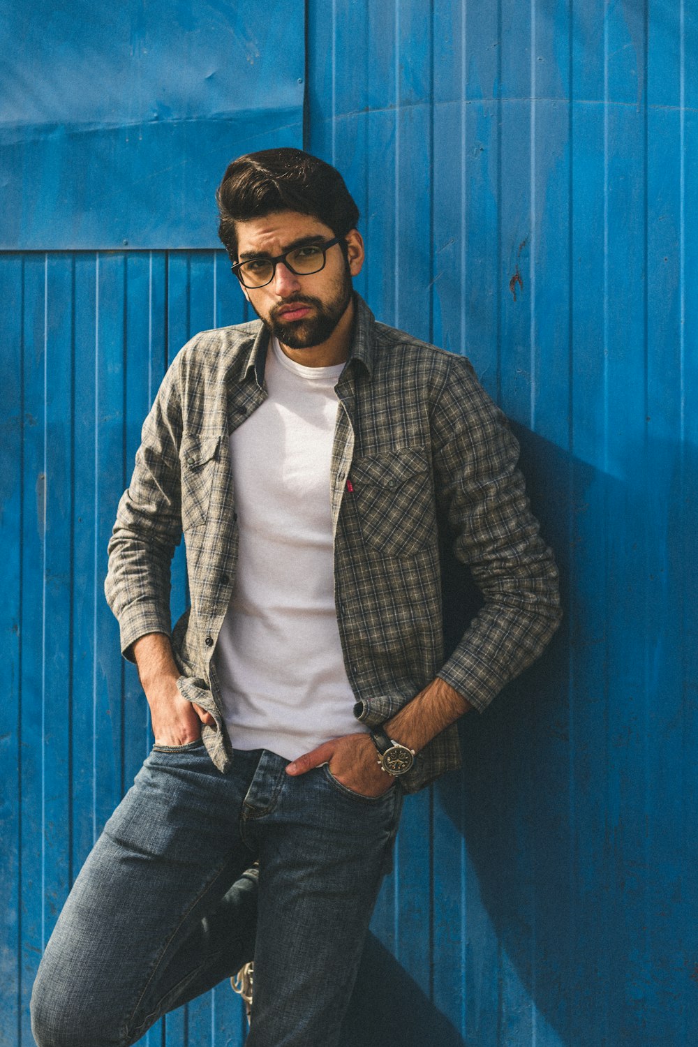 man standing near blue wall