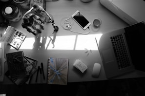 A playful setup of various tools and notes scattered on a desk, hinting at ongoing experiments