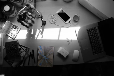 Close-up of a cluttered workspace with sketches and notes scattered around.