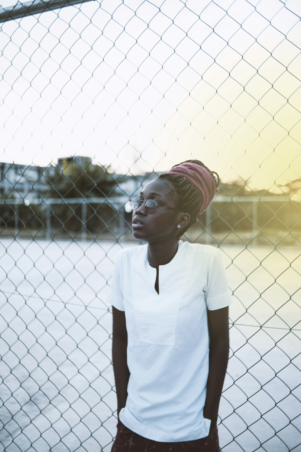 girl standing in front of fence