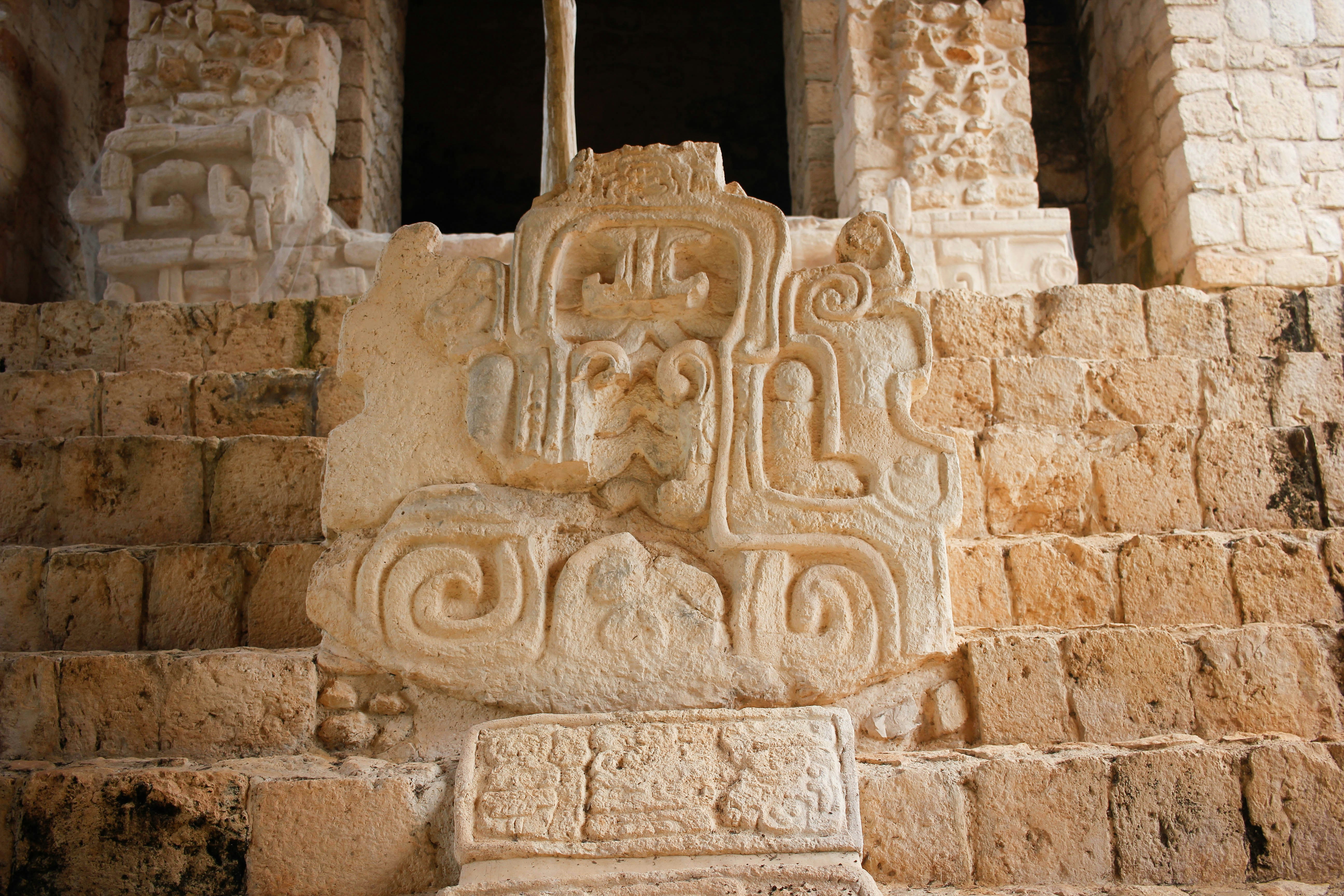abstract stone artwork in front of stairs, We went to Ek Balam, Mexican ruins in Yucatan.