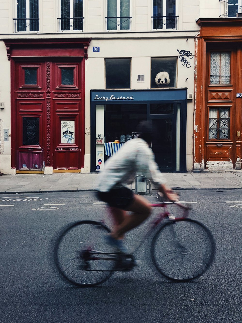 man riding on pink bicycle