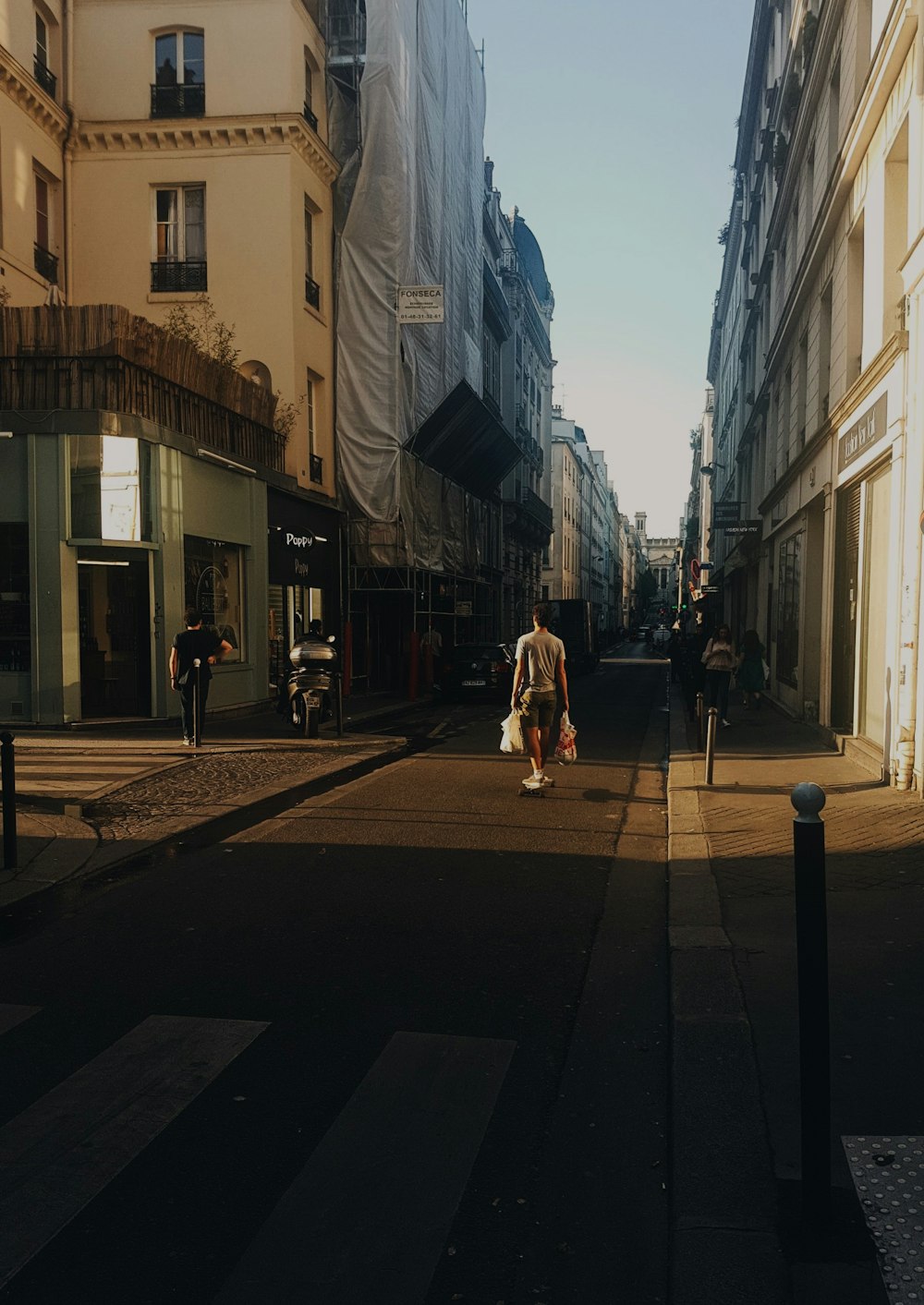 man standing beside buildings