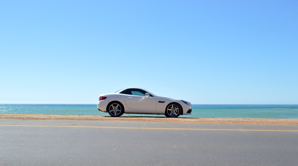 white coupe on road