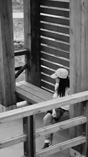 Vintage-inspired gratitude cap resting on a wooden bench by a park trail.