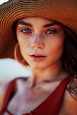 portrait photography,how to photograph afternoon sun with australian model akira isola, feeling the heat in her eyes,  almost tears appear,  emotion felt by all.  makeup by nikki de lima  please tag our instas if you use em @benscottphotographer; woman wearing sun hat and sleeveless top