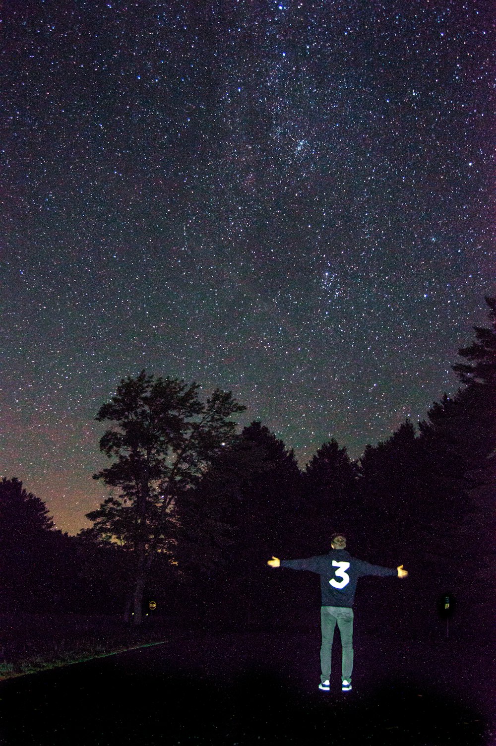 man standing in the road at nighttime