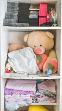 A cozy nursery filled with colorful baby clothes displayed on shelves.