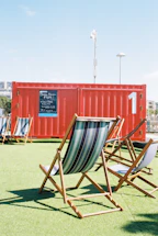 A bright mobile office container set up outdoors with clear signage.