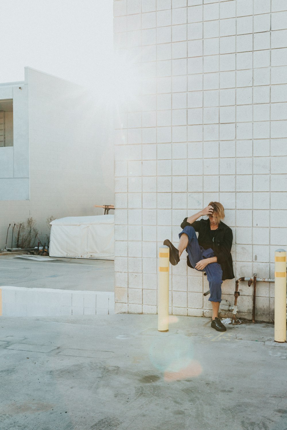 woman sitting beside water pipe