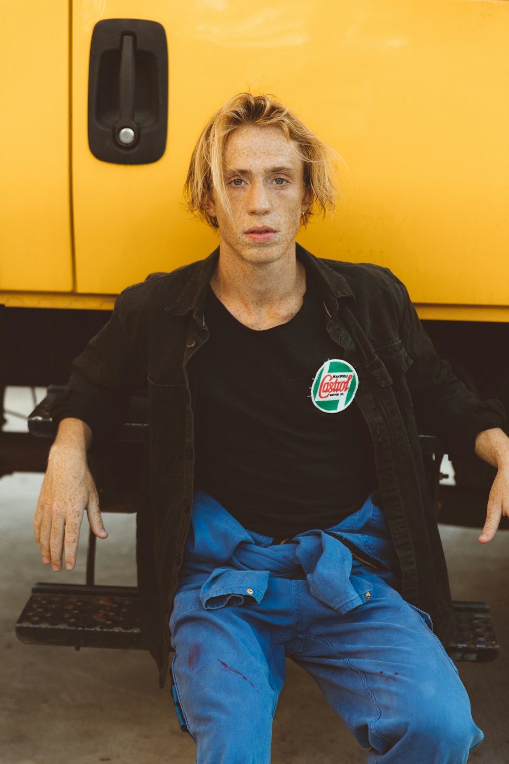 man sitting on truck side step bar