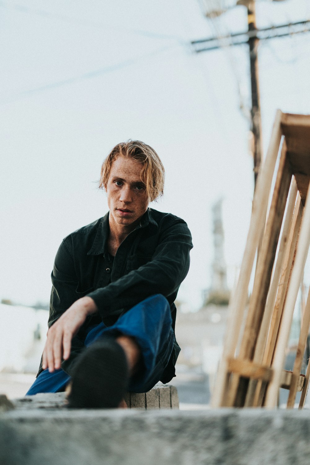 sitting man wearing black jacket during daytime