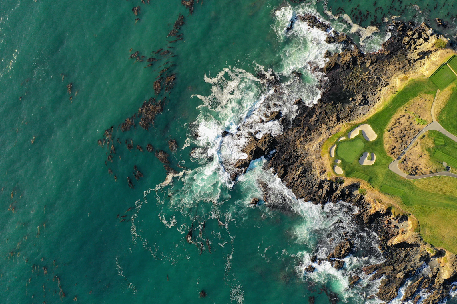 Aerial view of a coastal championship green beside the ocean