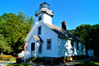 white and black wooden house near tree