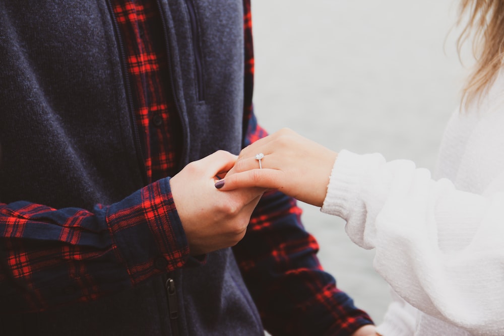 person holding left hand of another person