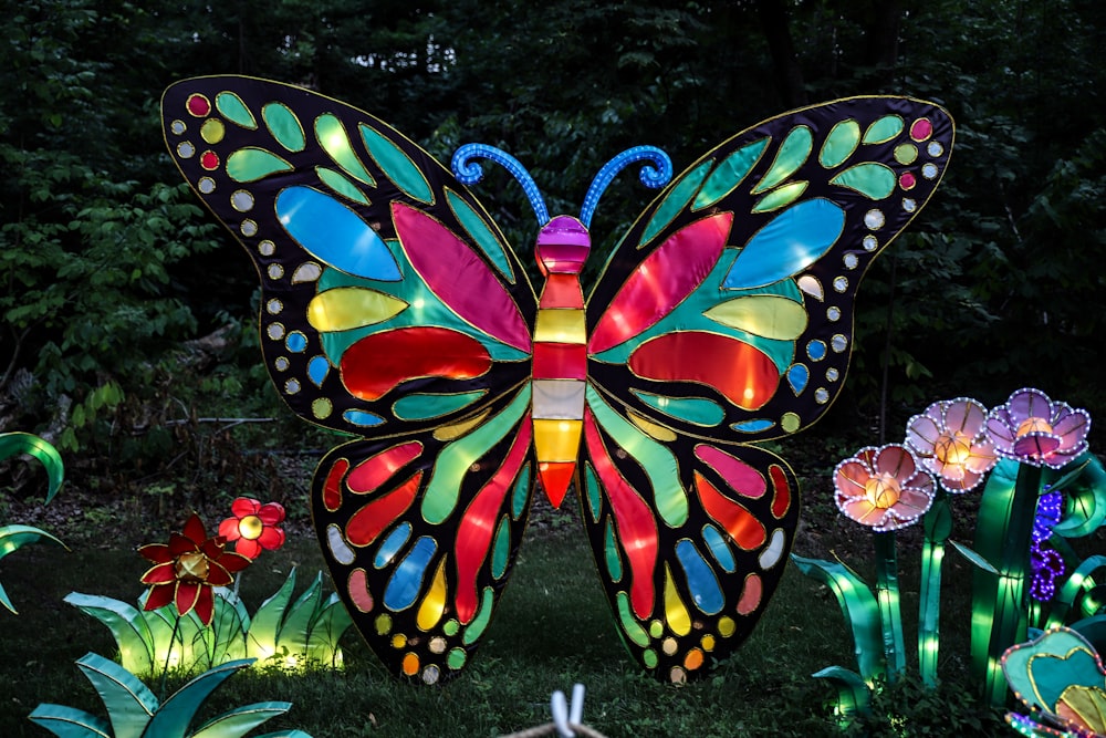 multicolored butterfly and flowers decors on lawn