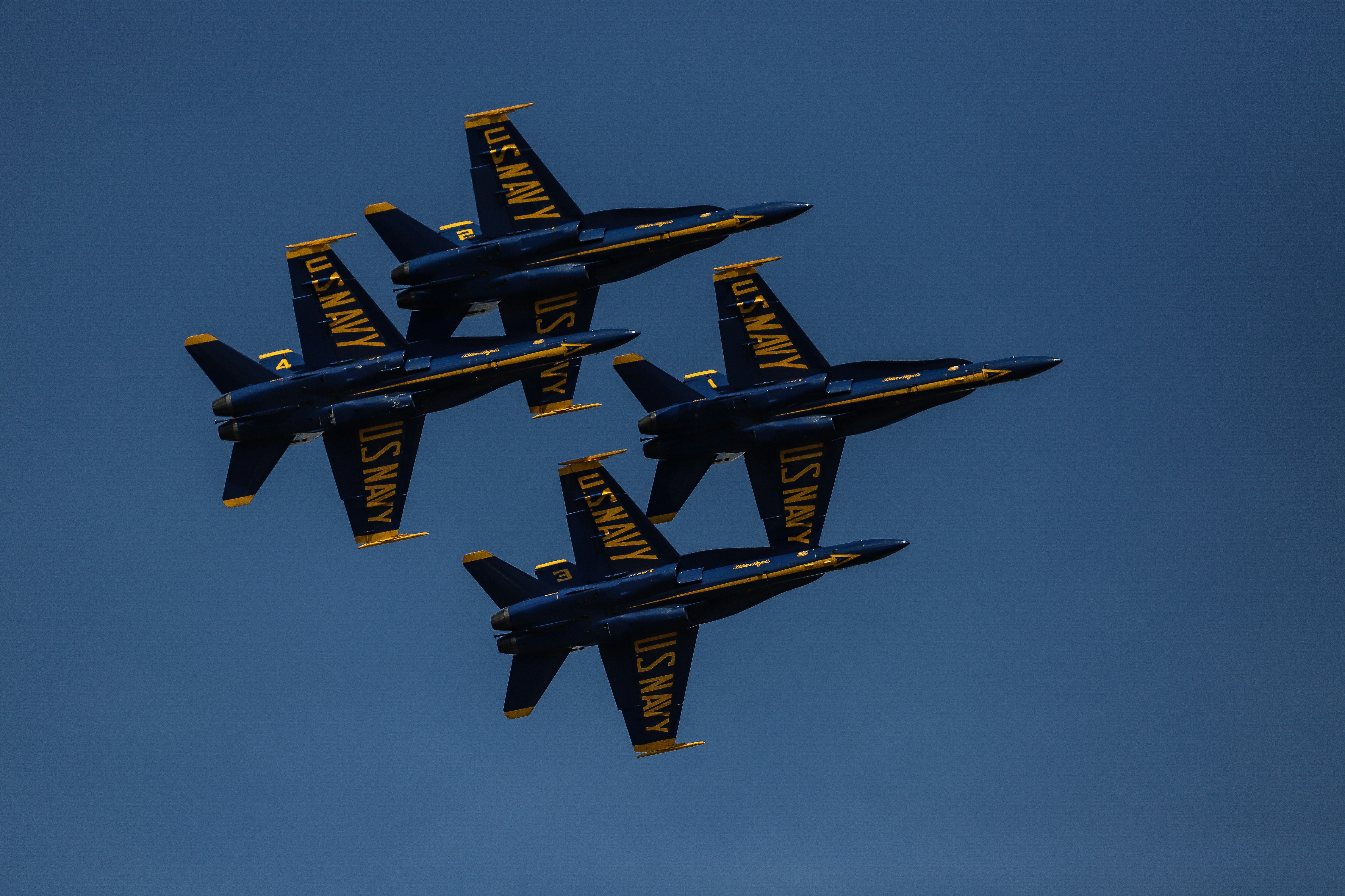 four black and yellow jet fighters