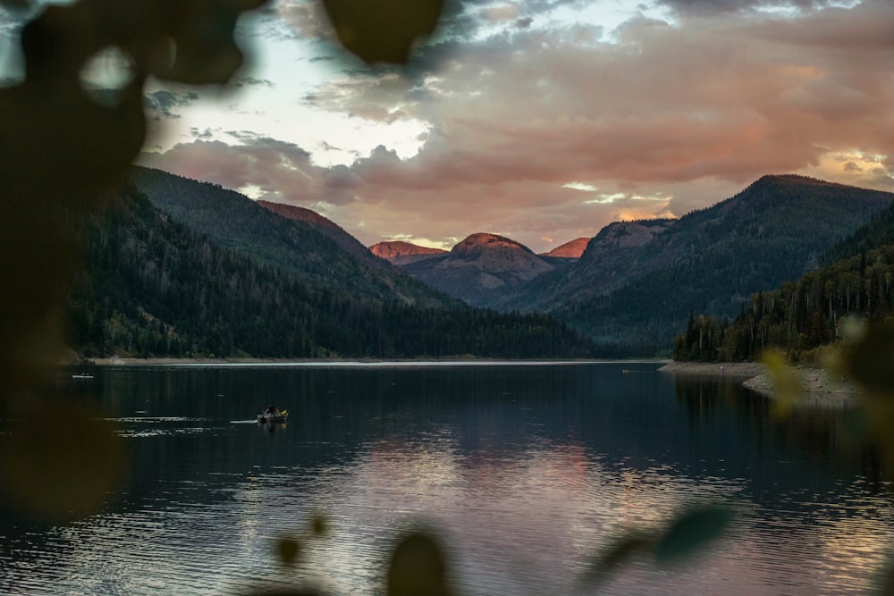 body of water, mountains, and clouds