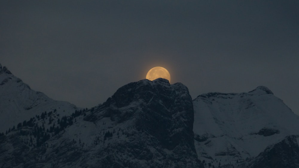 snow covered mountain during golden hour