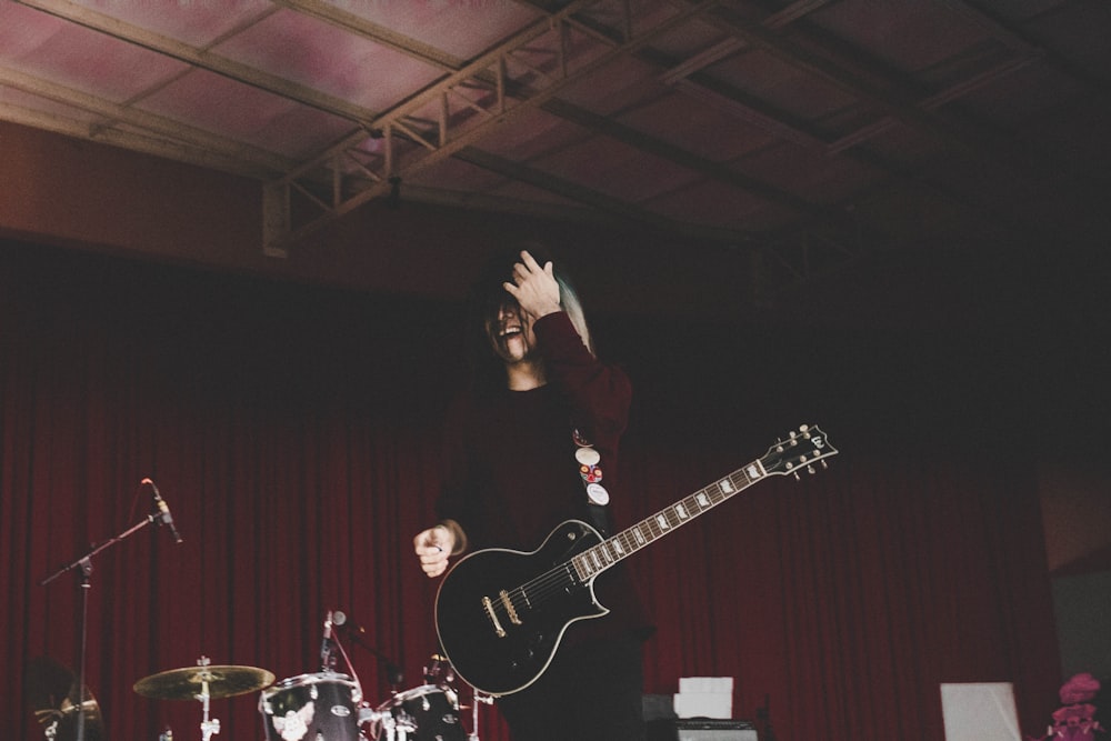 man playing guitar on the stage