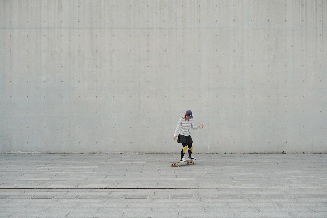  woman riding on skateboard during daytime wall