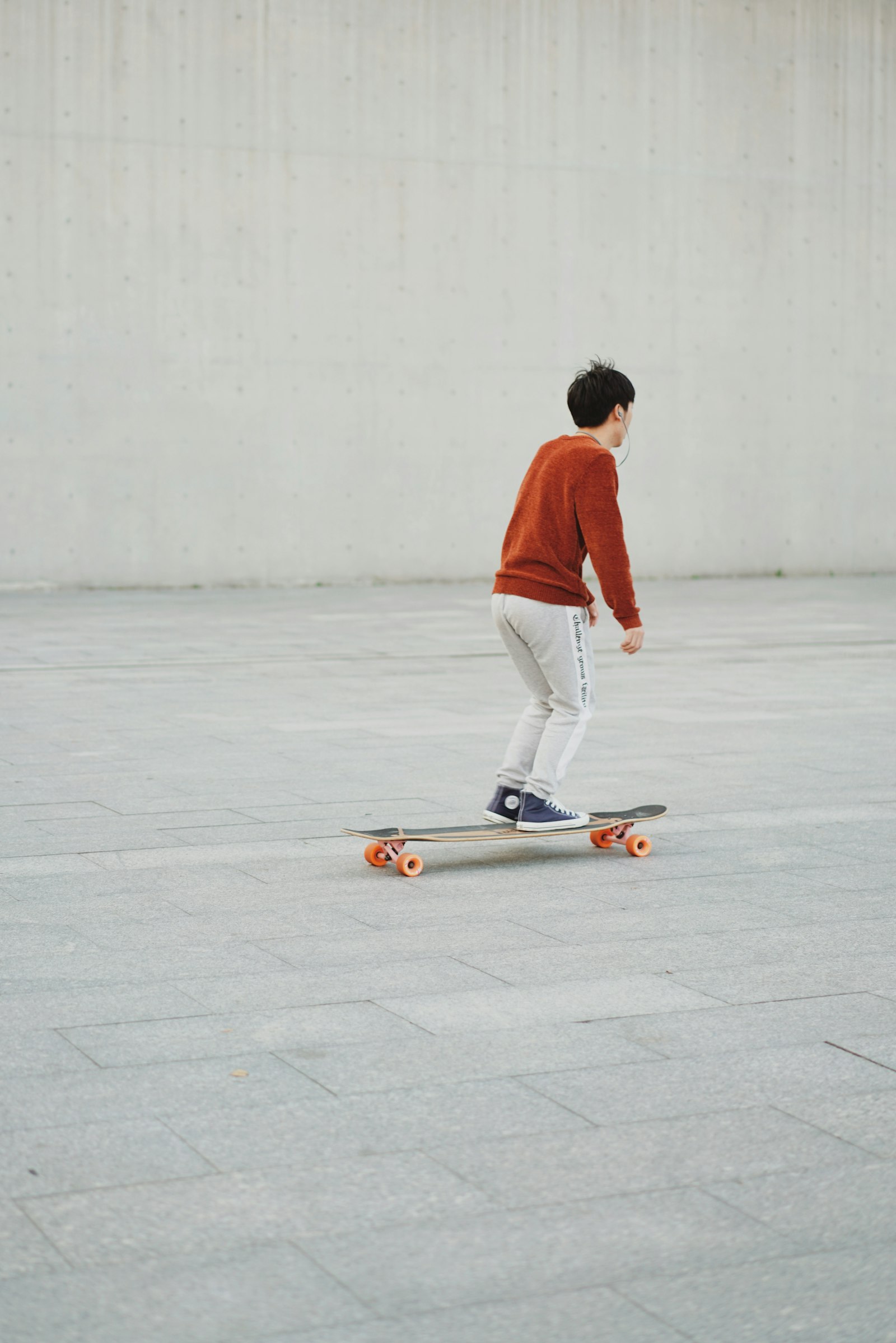 Sony Sonnar T* FE 55mm F1.8 ZA sample photo. Man skating on pavement photography