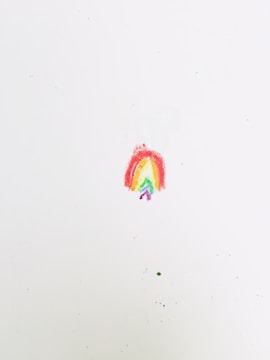 An illustration of a child painting a rainbow with crayons.