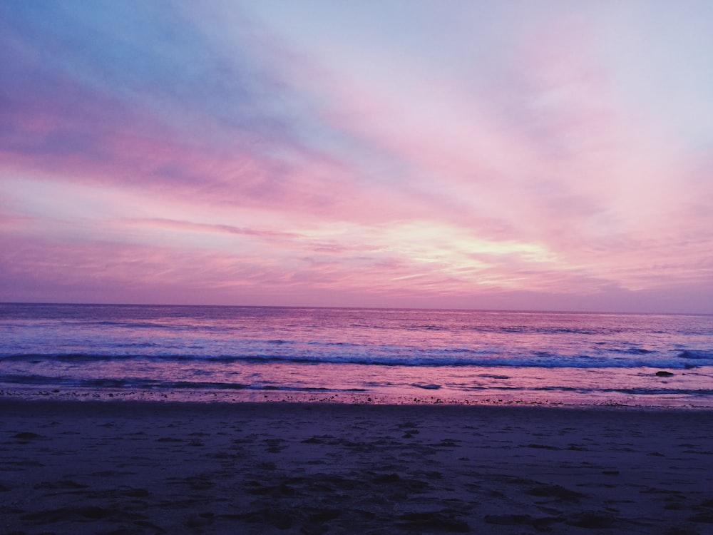 calm sea under orange and blue skies