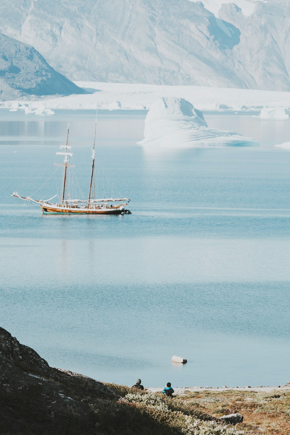 white sailing boat on body of water