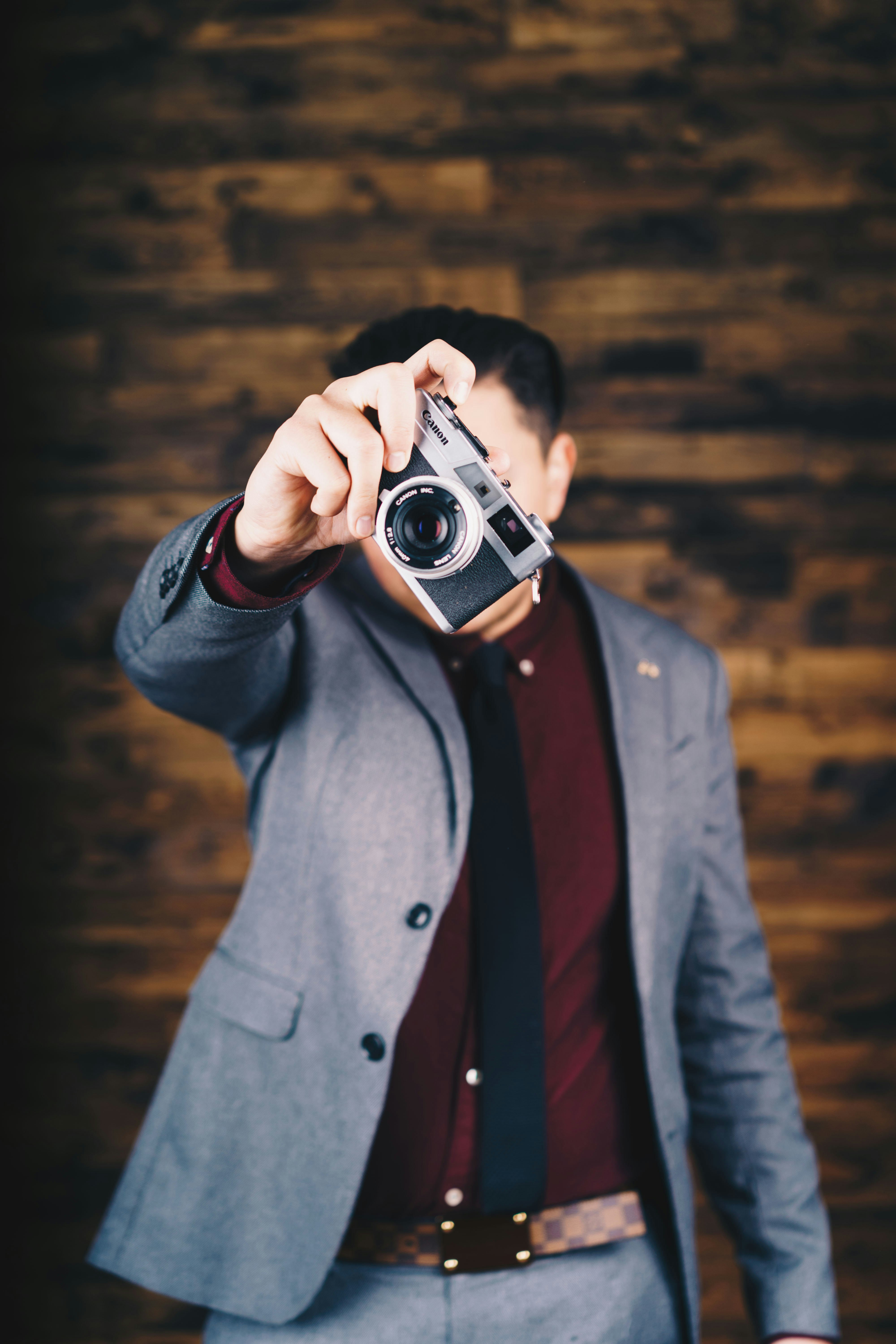 man holding mirrorless camera