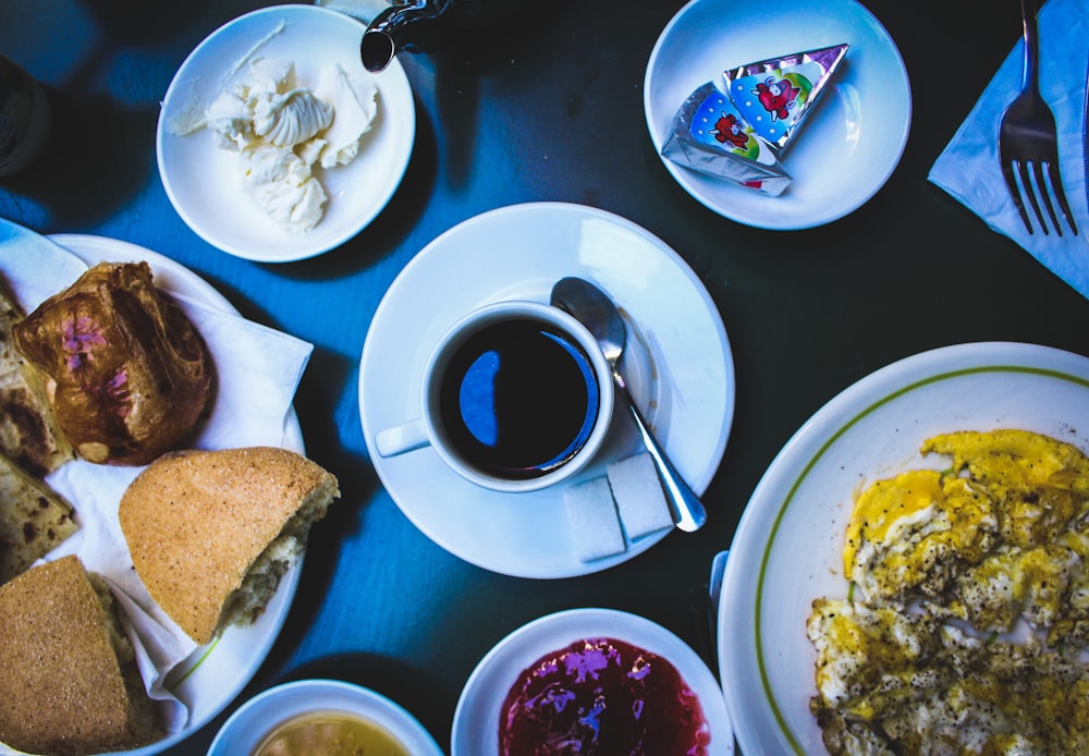 cooked foods on plate and black coffee