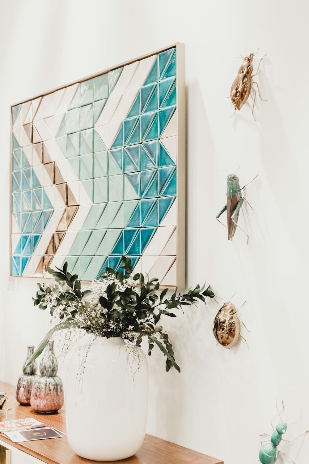 green and white wooden wall decor near vase