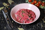 A variety of colorful risotto jars arranged on a wooden table with fresh ingredients around.
