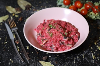 A variety of colorful risotto jars arranged on a wooden table with fresh ingredients around.