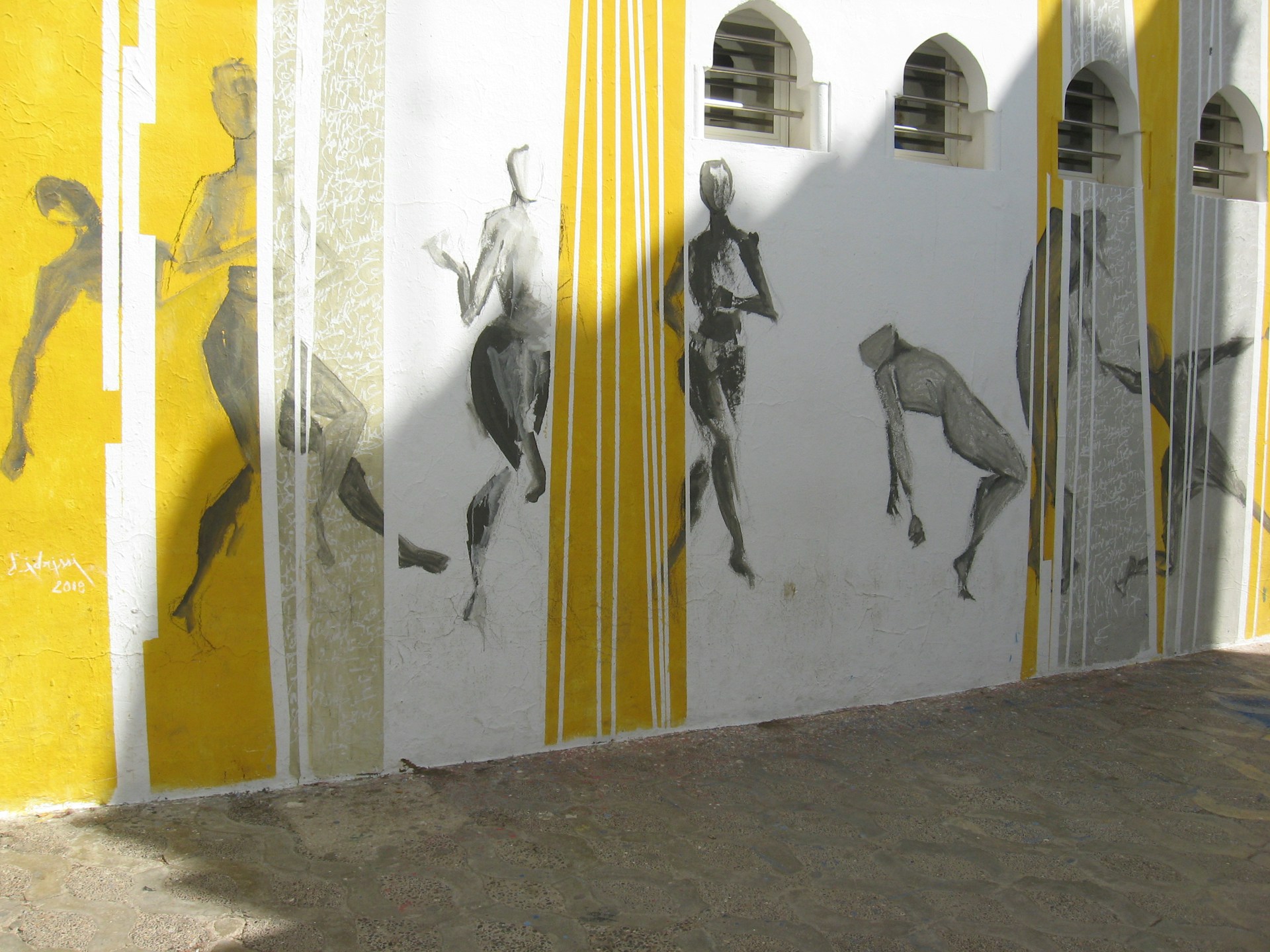 woman wearing yellow long-sleeved dress under white clouds and blue sky during daytime
