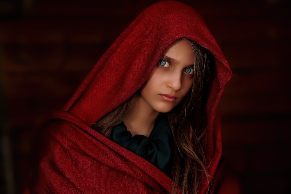 woman with blue eyes wearing red shawl