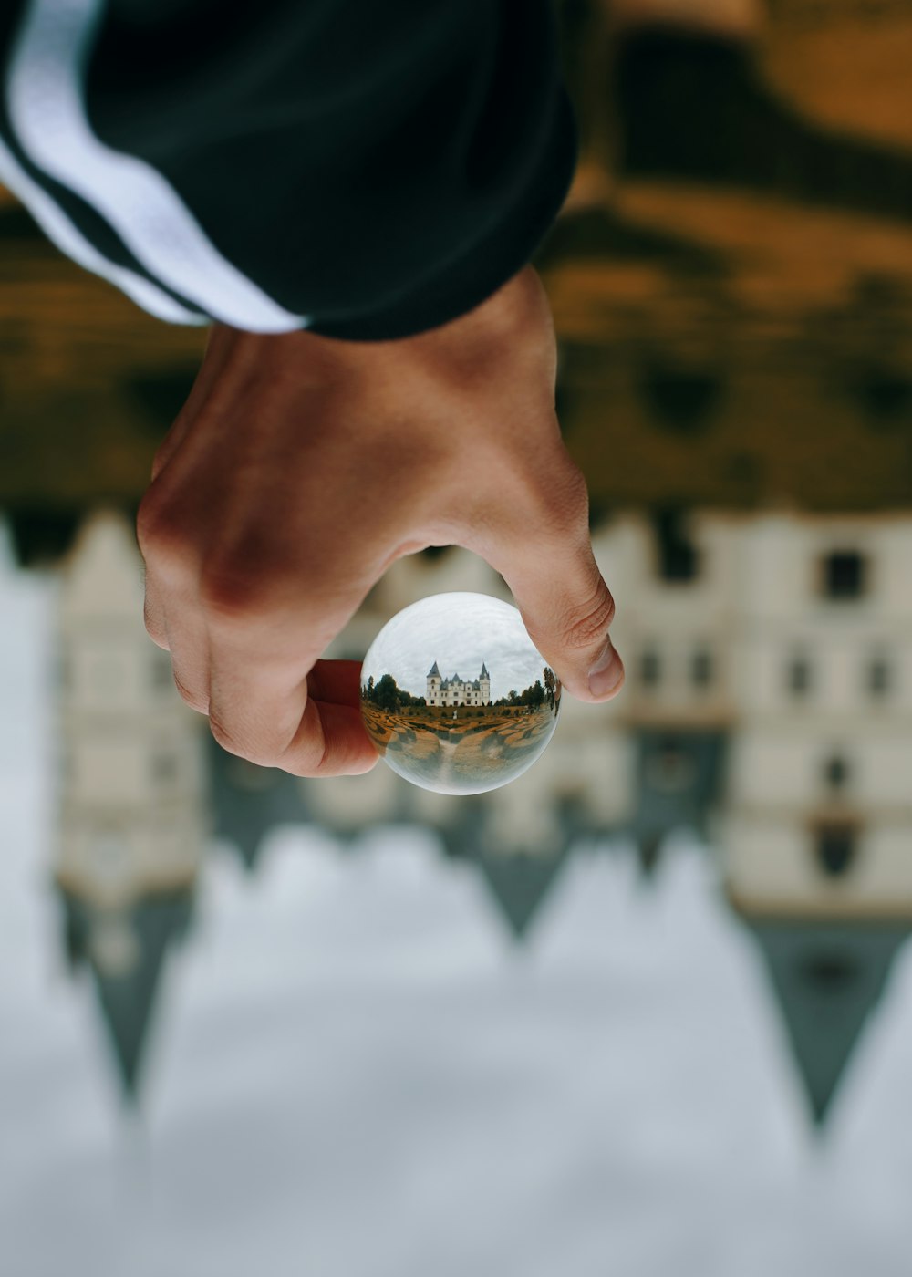 person holding glass ball