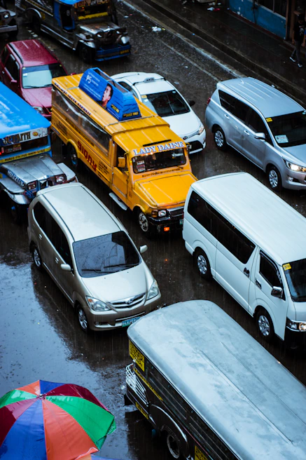 Compact hybrid SUV navigating through a bustling Philippine city road