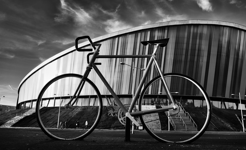 grayscale photography of road bike near stadium