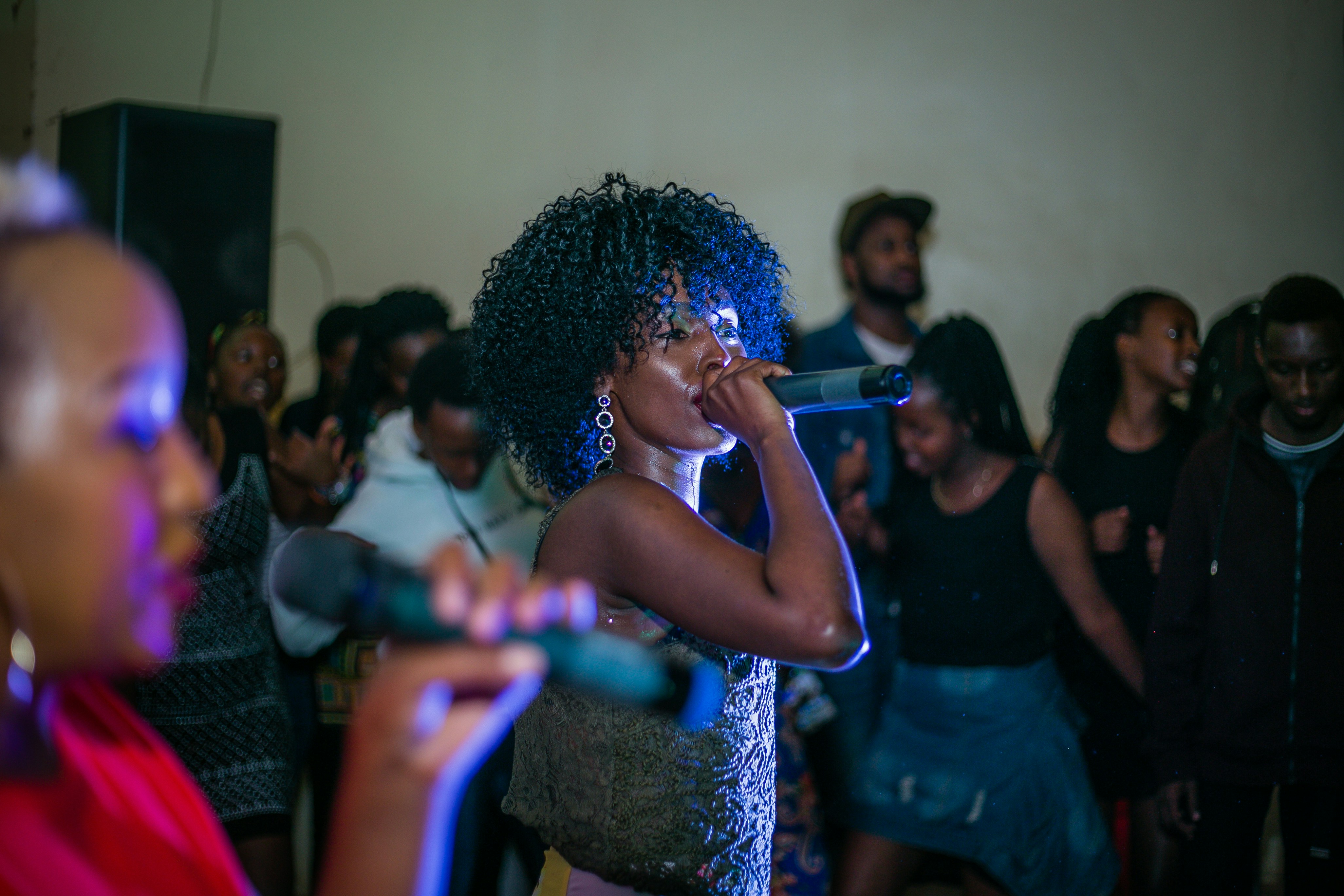 woman singing near people, Nina (Rwanda)
