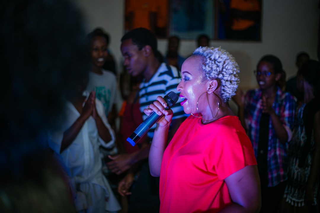 woman singing beside man dancing, Charly (RWANDA)