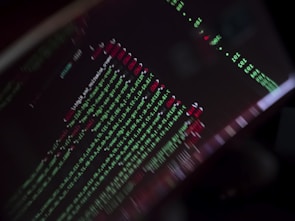 Close-up of a computer screen displaying AI code and data visualizations.