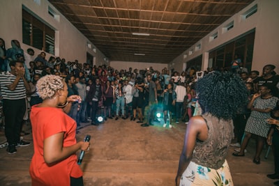 woman holding microphone inside the room rwanda teams background