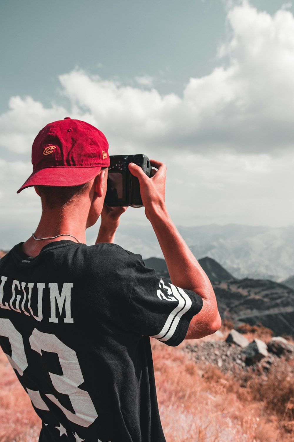 man taking photo of mountain