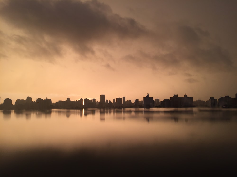 grayscale photography of city near body of water